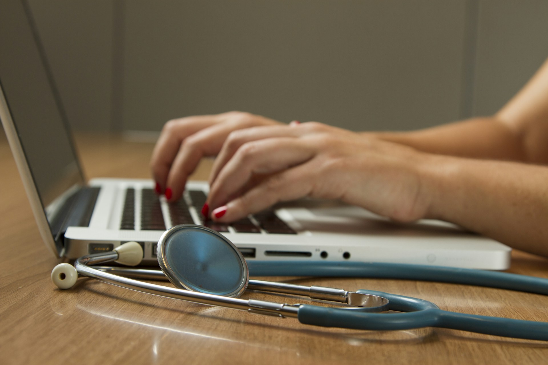 Healthcare practice team managing patient payments with a laptop and medical equipment